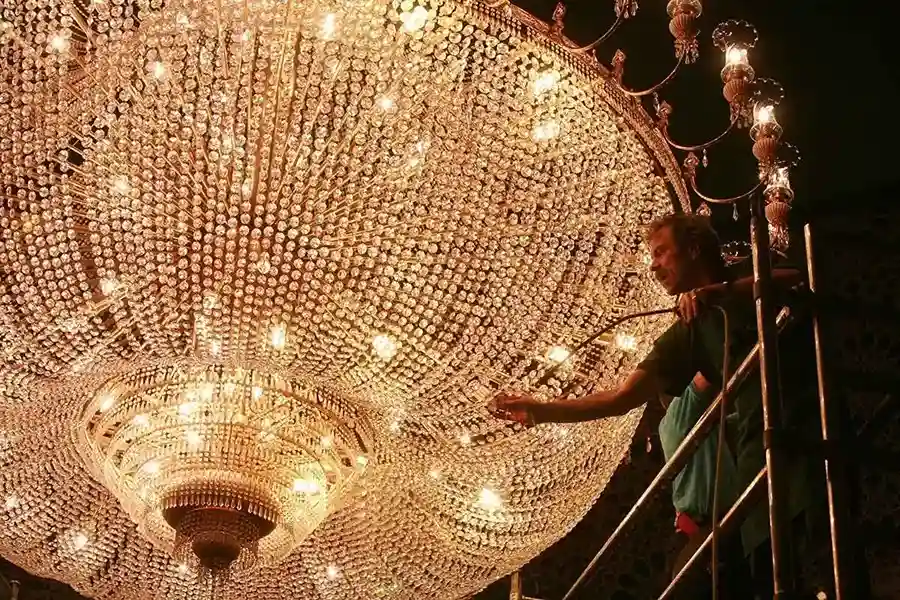 worker performing Cleaning on a chandlier